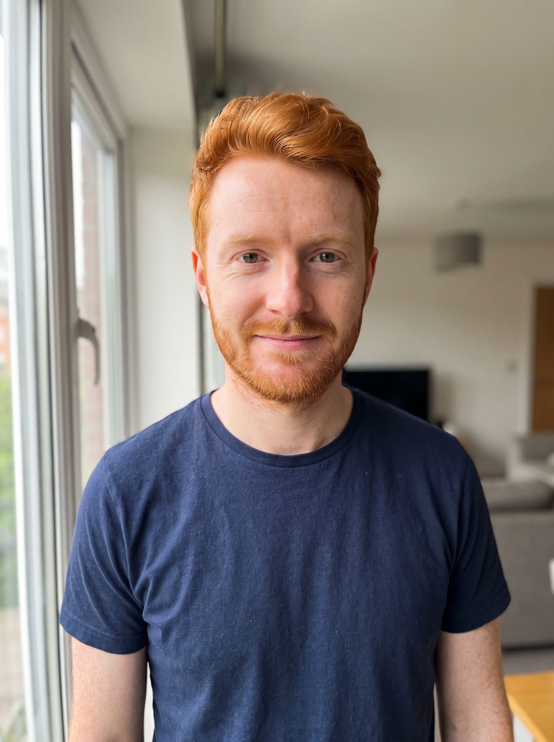 Jonah, one of four friends, seen beside a window.